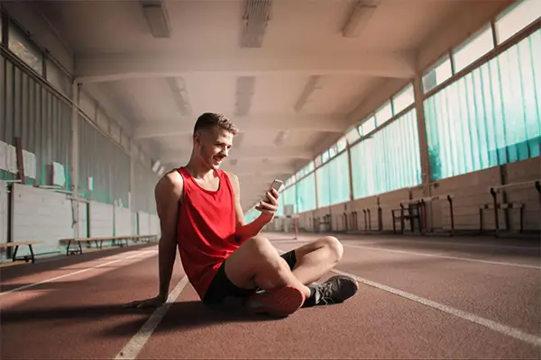 Athlete Using Phone